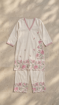 Cream base fabric with pink and green floral embroidery